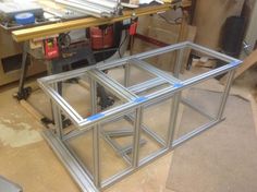 a metal frame sitting on top of a table next to a workbench and tools