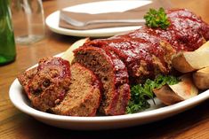 meatloaf and potatoes on a white plate with garnish