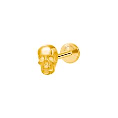 a gold skull shaped earring on a white background