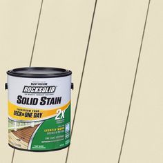 a white paint can with the words rocksolid solid stain next to it on a wooden deck