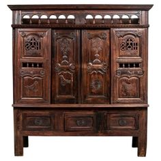 an old wooden cabinet with ornate carvings on the front and side doors, isolated against a white background