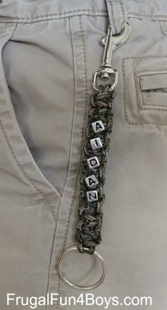 a close up of a keychain on a person's pants with buttons