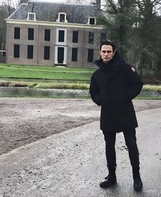 a man standing in front of a large building