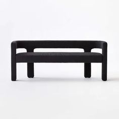 a black bench sitting on top of a white floor