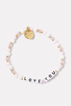 Show some love with this beaded bracelet by Little Words Project, handcrafted with “Love You” lettering, pink and white beads, and stretch elastic for easy on-and-off. Alone or stacked, it makes the perfect gift for yourself or a loved one. Little Words Project encourages you to wear your word to lift you up, and then pass it on to someone who needs it more. Each bracelet comes with a unique ID tag. Use this code to register your bracelet on the Little Words Project website to join the community and track your bracelet’s journey from person to person. | LITTLE WORDS PROJECT Women's Love You Bracelet, Size Small/Medium, Pink Cheap Adjustable Pink Name Bracelet, Loving You Letters, Project Website, Little Words Project, Pearl Beaded Bracelet, Spreading Kindness, Neoprene Bag, Show Yourself, Bracelets Ideas