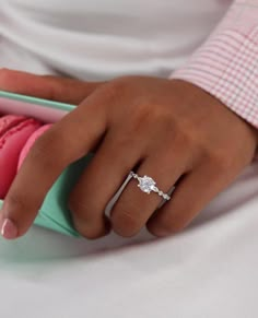 a close up of a person's hand with a ring on their finger