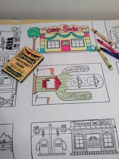 this is an image of a coloring book page with cars and buildings on it, along with crayon pencils