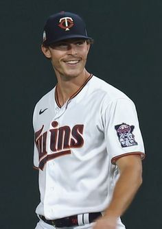 a baseball player is smiling for the camera