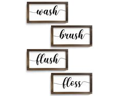 three wood framed signs with the words wash brush floss in black ink on them