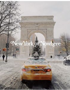 a yellow car is parked in front of the arc de trioe on a snowy day