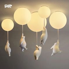 some white lights hanging from the ceiling with animals on them