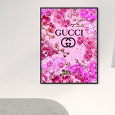 a gucci poster hanging on the wall above a bed in a room with white walls