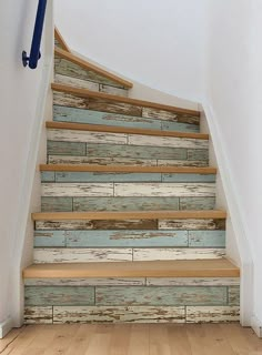 the stairs are painted with blue and white wood planks as well as wooden flooring