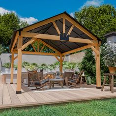 a wooden gazebo sitting on top of a lush green field