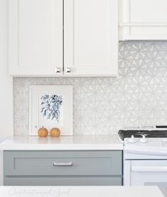 a white stove top oven sitting inside of a kitchen next to an oven and microwave