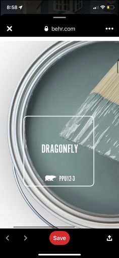 a paint can with the words dragonfly painted on it and a brush in front of it