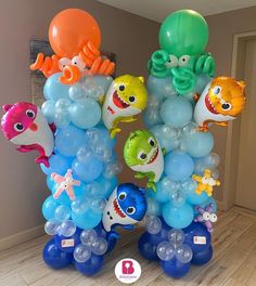 there are many balloons in the shape of sea animals and fish on this birthday party