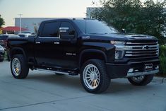 a black truck parked in front of a building