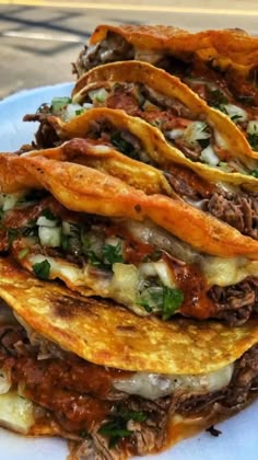 three tacos stacked on top of each other