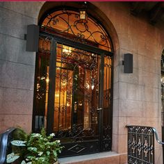 the entrance to a building with an iron door and wrought iron railings on either side