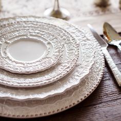 white plates and silverware on a wooden table