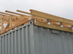 a metal container with wooden beams on top