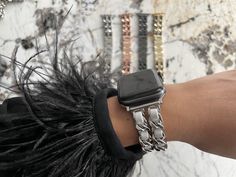 a woman's arm with an apple watch on it and some bracelets around her wrist