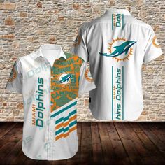 the miami dolphins shirt is on display in front of a brick wall and wooden floor