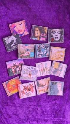 various cd's laid out on a purple blanket