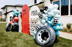 some balloons are on display in front of a building with surfboards and other decorations