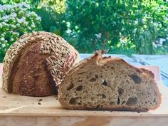 two loaves of bread sitting on top of a cutting board