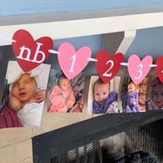 several hearts are hanging on a clothes line with the numbers 1, 2, 3 and 5