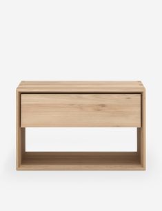 the side table is made from wood and has an open shelf on one end, with two