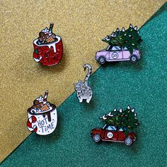 three pin badges with cars and christmas trees on them, one has a hot time sign