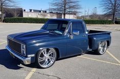 a blue pickup truck parked in a parking lot