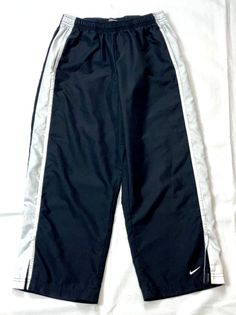 Nike  Women's  Black w/White Stripe  Lightweight Athletic Capri Crop Pants  Size M (8 - 10)  Inseam 22 inches Features: Stretchy Waist, Pockets, Drawstring Item will be packed and shipped with care  Shipped within 1 business day of payment  See excellent customer feedback, experienced, long time seller ALL ITEMS COME FROM A CLEAN, SMOKE FREE HOME *** IF you have any problems or concerns once you receive  the item(s) please email me to work something  out before leaving negative feedback.  I pers Nike Parachute Pants, Nike Track Pants, Customer Feedback, Crop Pants, Nike Pants, Baggy Jeans, Pants Black, School Outfits, Fitness Inspo