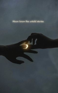 two hands touching each other with the moon in the background