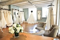 the bridal gowns are on display in the store's dressing room area