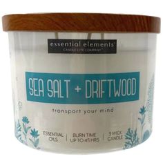 a jar of sea salt and driftwood scented candle on a white background with wooden lid