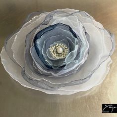 a close up of a flower on a metal surface