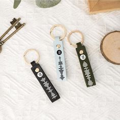 three keychains with different designs on them