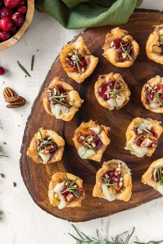 small appetizers with cranberry sauce and nuts on a wooden platter