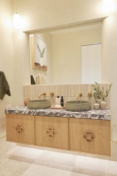 a bathroom with two sinks and a mirror