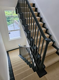 there is a stair case in the house with carpet on the floor and an open window