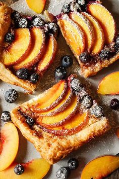 sliced peaches and blueberries on top of pastry