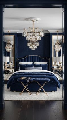 a bedroom with dark blue walls and gold accents, chandelier above the bed