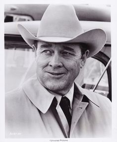 black and white photograph of a man wearing a cowboy hat