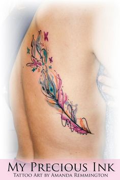 the back of a woman's stomach with an artistic tattoo design on her left side