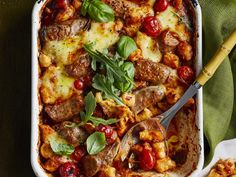 a casserole dish with meat and vegetables in it on a green table cloth