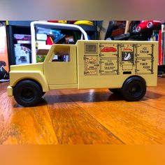 a yellow toy truck sitting on top of a wooden table